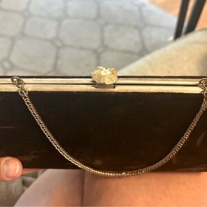 Vintage brown velvet clutch with gold tone hardware and attached chain.